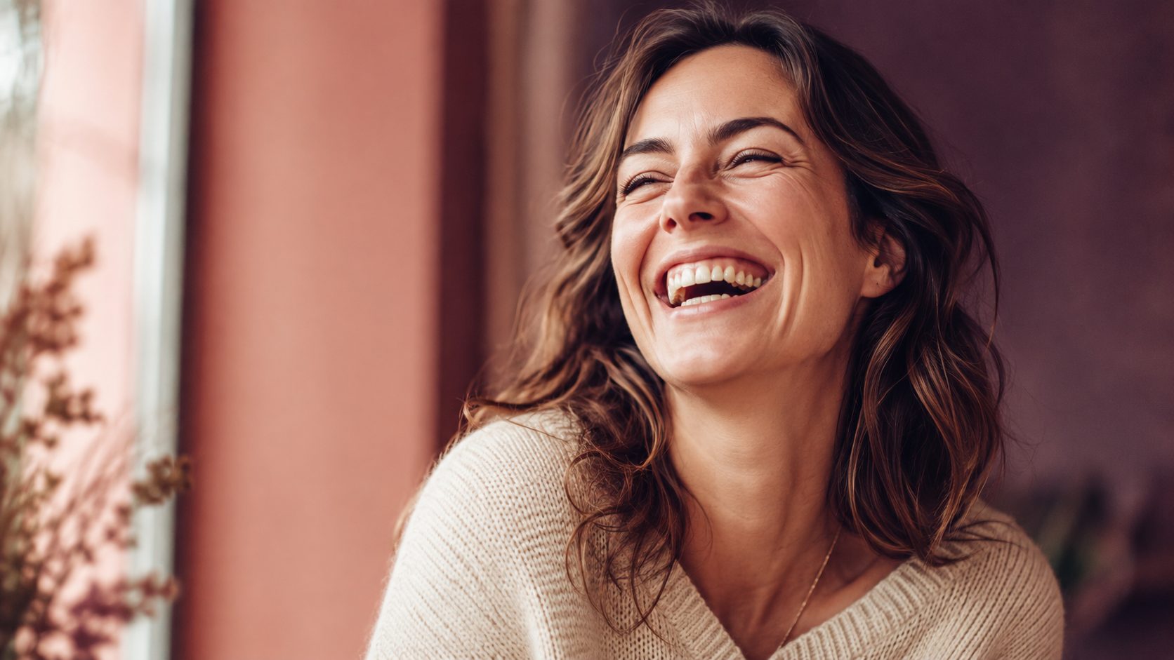 Woman laughing joyfully, head tilted back